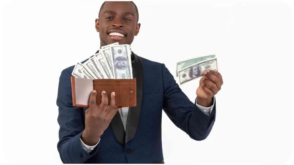 a person in a suit holding a wallet full of money