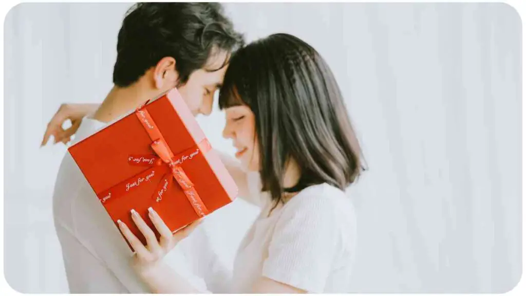 a person holding a red gift box